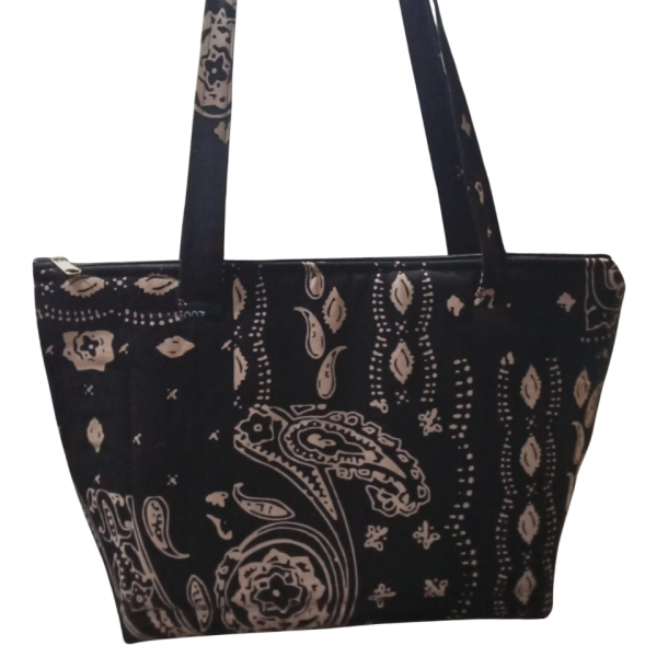 Upgrade your daily carry with our African Print Zip-Top Tote. Perfectly balancing functional design with high-impact aesthetics, this bag takes you from morning meetings to weekend brunch without missing a beat. Product Features: Secure Closure: Durable top zipper to keep your essentials safe. Spacious Design: Roomy interior for your laptop, makeup bag, and daily essentials. Sturdy Straps: Reinforced shoulder straps for comfortable all-day wear. Premium Fabric: 100% authentic African Wax Print (Ankara) with a structured lining.