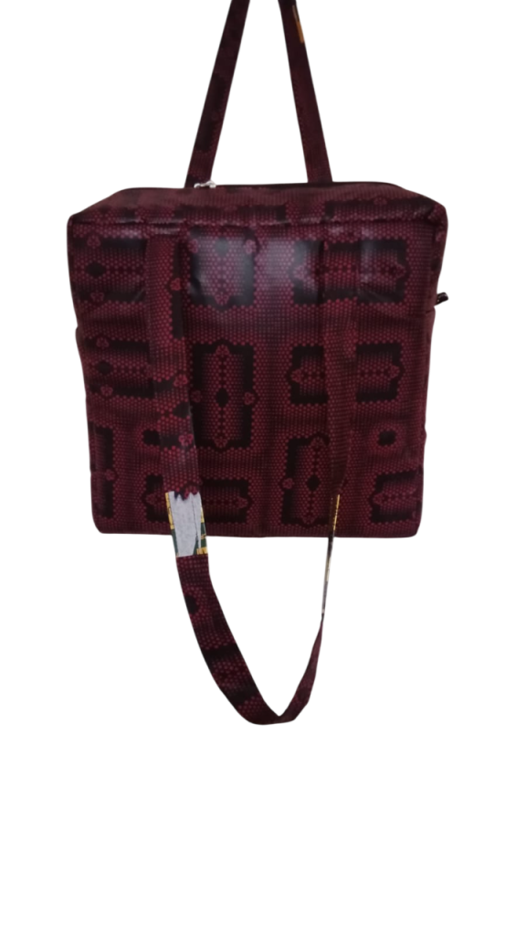 Upgrade your daily carry with our African Print Zip-Top Tote. Perfectly balancing functional design with high-impact aesthetics, this bag takes you from morning meetings to weekend brunch without missing a beat. Product Features: Secure Closure: Durable top zipper to keep your essentials safe. Spacious Design: Roomy interior for your laptop, makeup bag, and daily essentials. Sturdy Straps: Reinforced shoulder straps for comfortable all-day wear. Premium Fabric: 100% authentic African Wax Print (Ankara) with a structured lining.